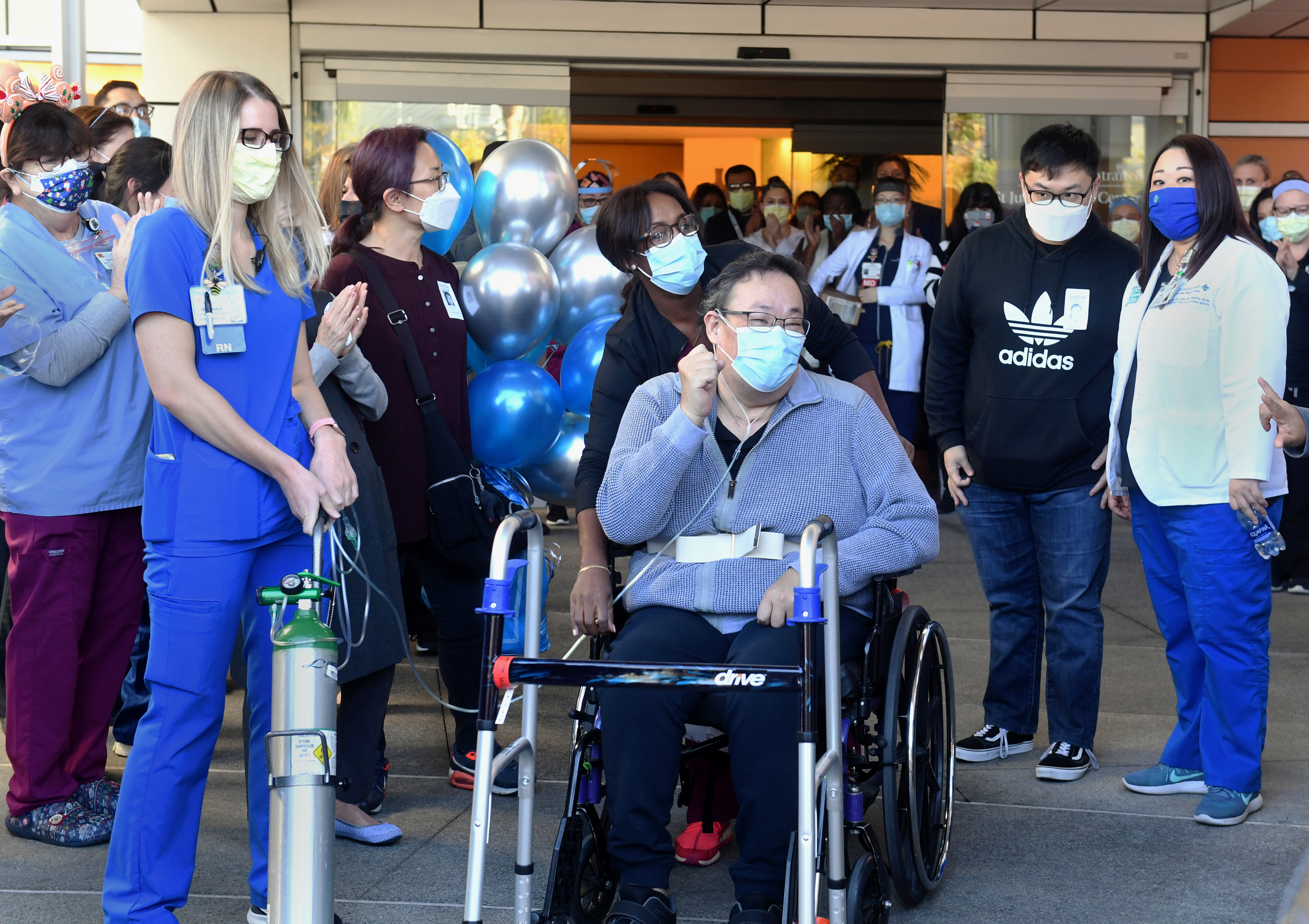 Hospital staff applaud Southern California resident Daniel Kim as he heads home after a five-month battle with COVID-19