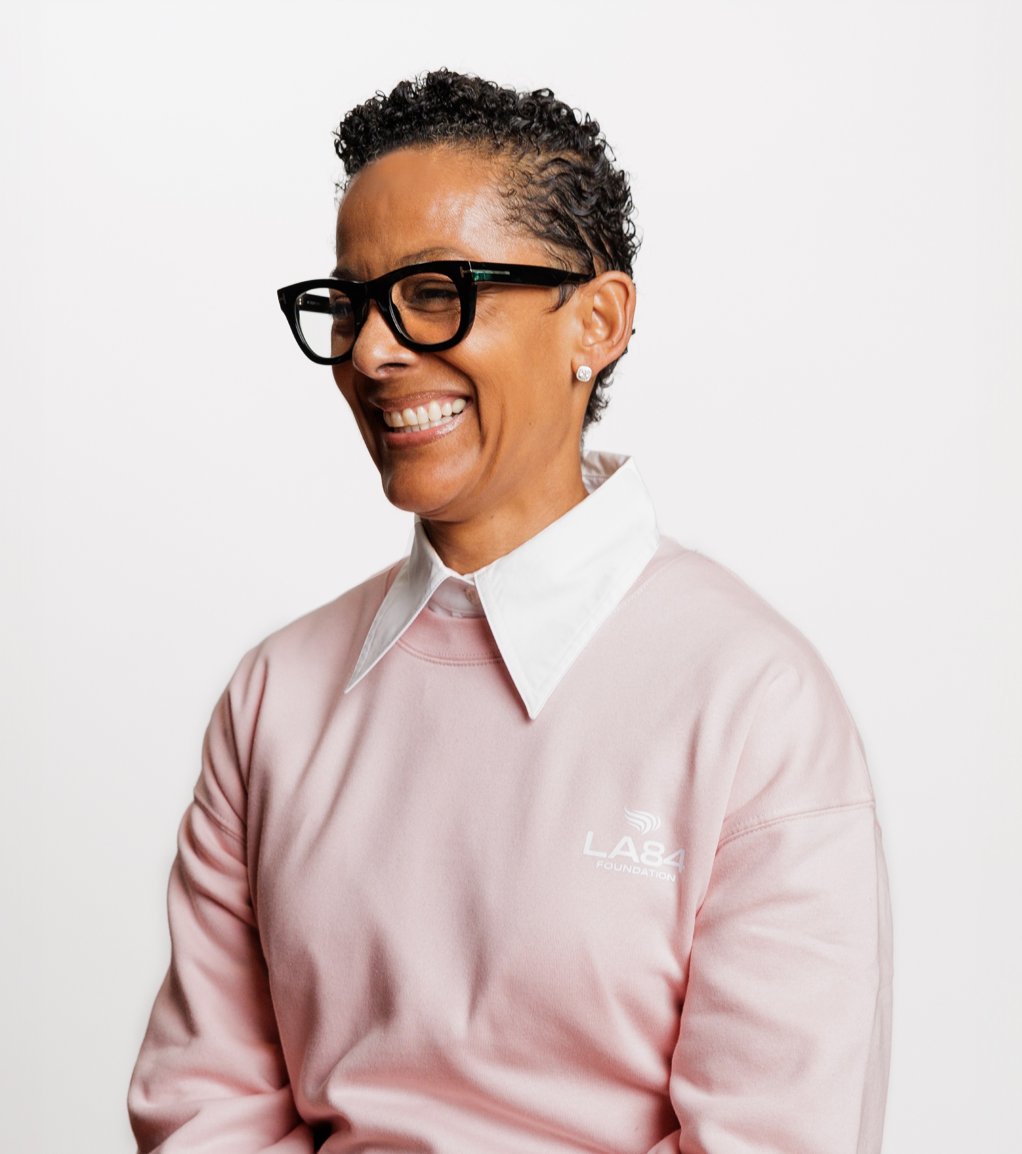 Renata Simril looking to the left, wearing pink LA84 sweater