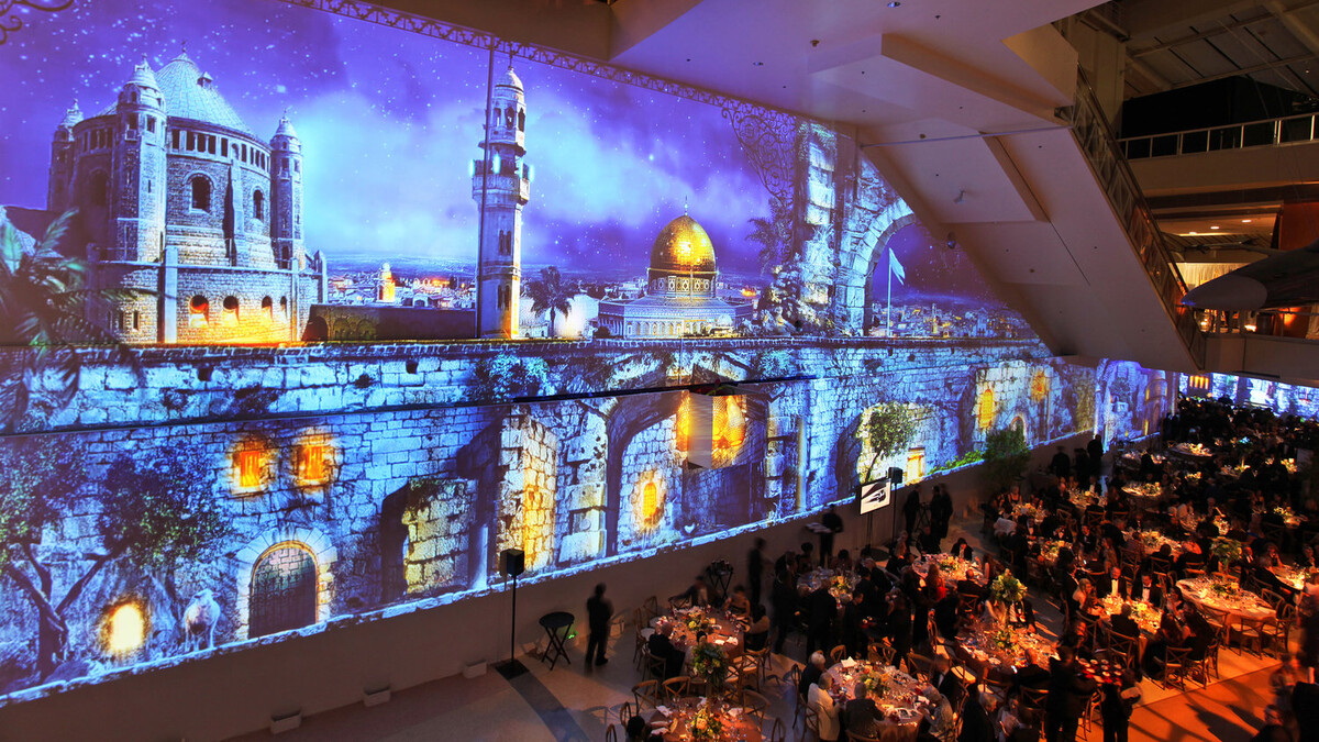 Edgerton Court seated dinner with blue hued night projection mapping of Jerusalem