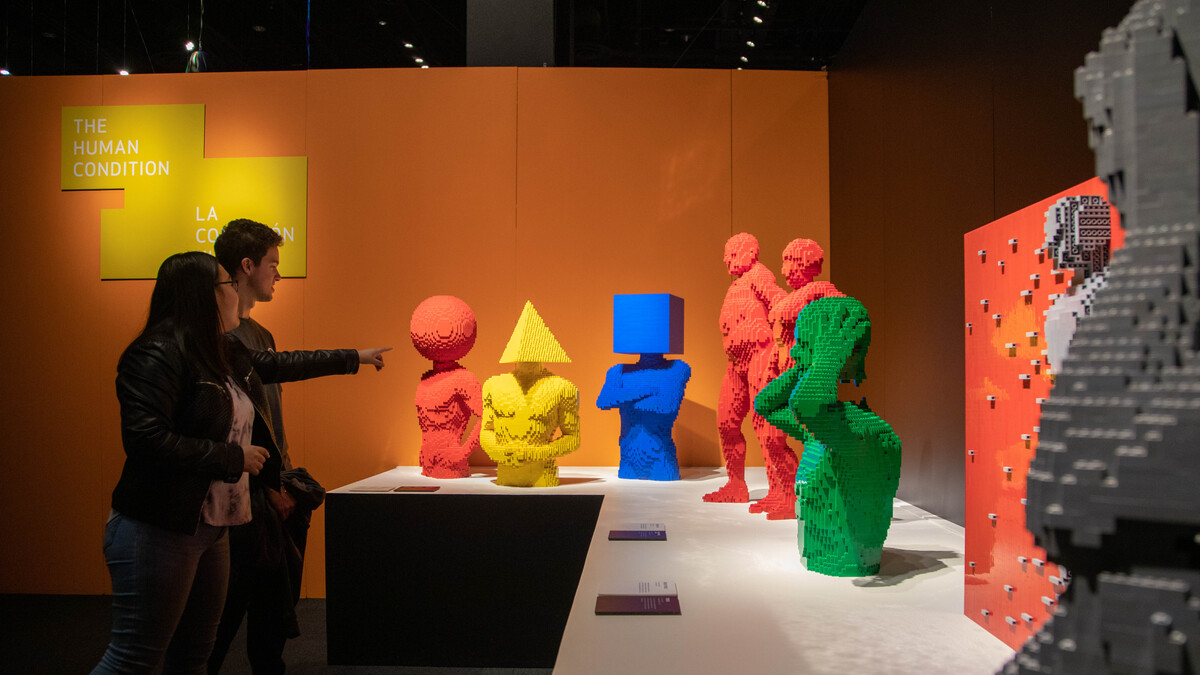 Visitors viewing shape sculptures in The Art of the Brick exhibition