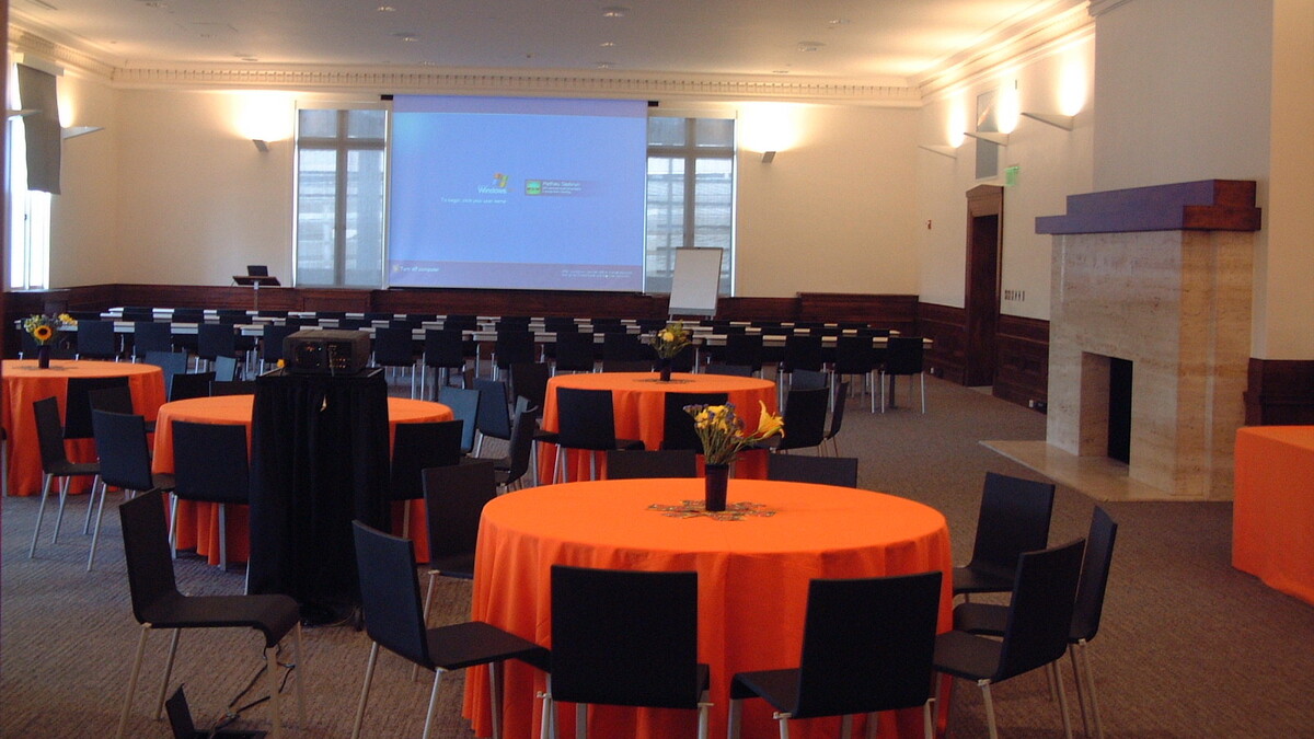 Erteszek Family Foundation Muses Room set with banquet rounds with orange linens
