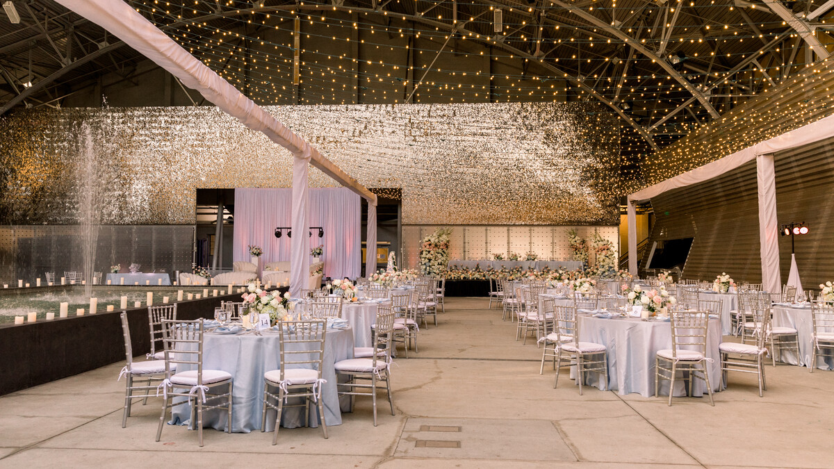 A white and gold hued banquet wedding reception on the West side of the Wallis Annenberg Building Big Lab.