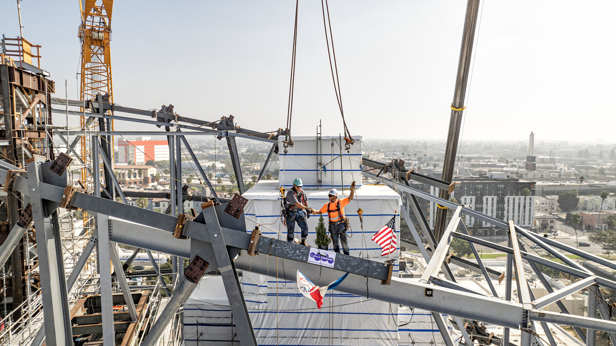 Final steel beams are installed on the diagrid structure for the Samuel Oschin Air & Space Center at the California Science Center