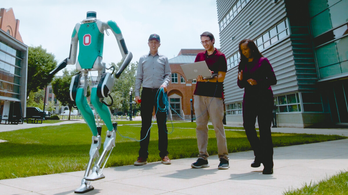 Roboticist Dr. Ayanna Howard and her two colleagues test their physical therapy robot outdoors on the campus of The Ohio State University.