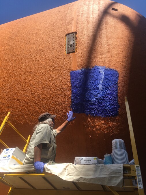 A mold maker puts purple silicone on the external tank to take an impression of the foam.