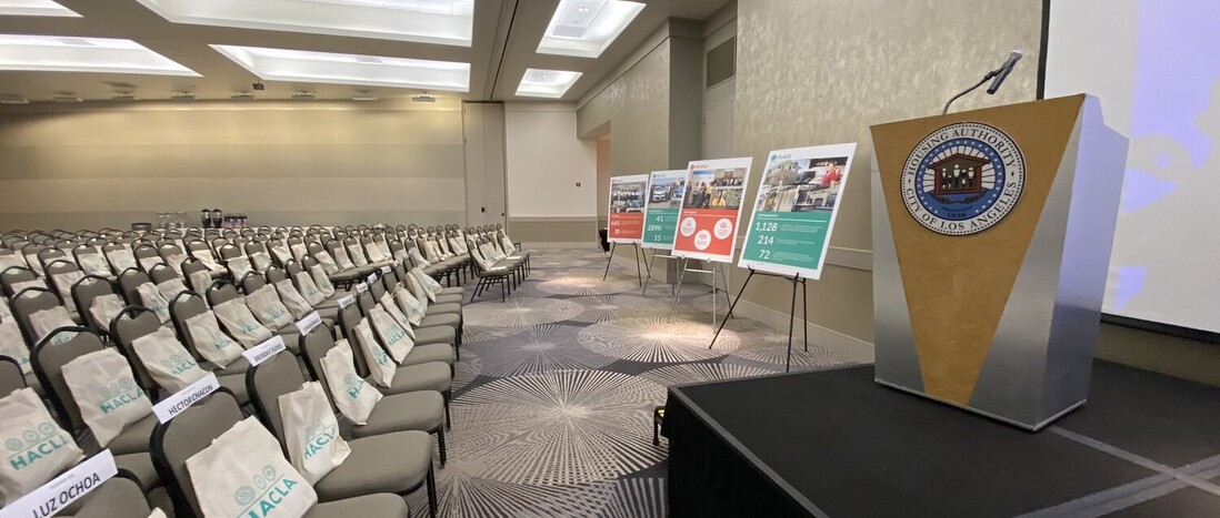 Empty Theater Style Meeting with swag bags on chairs facing stage and podium in the Loker Conference Center