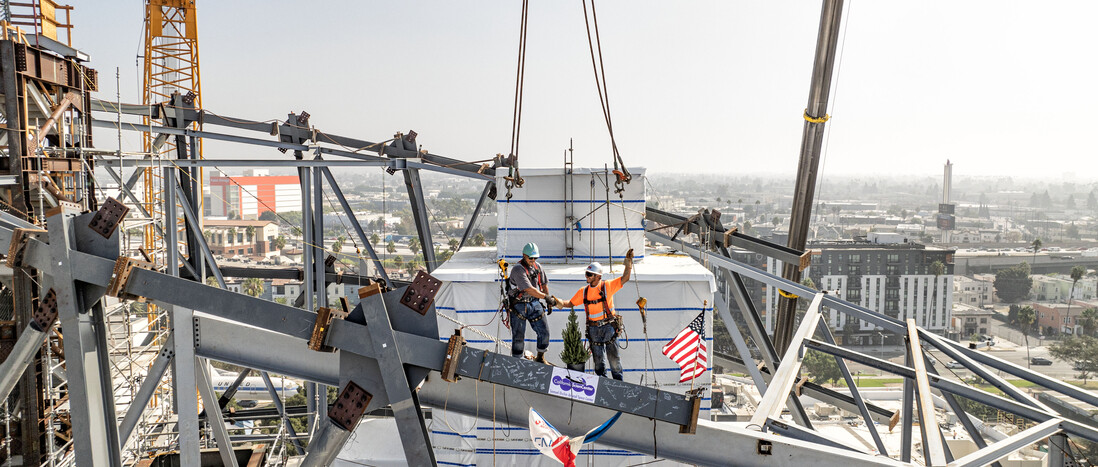 Final steel beams are installed on the diagrid structure for the Samuel Oschin Air & Space Center at the California Science Center